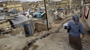 An Iranian woman walks in a poor neighbourhood in the town of Ghaleh Hassan Khan on the southwestern outskirts of Tehran on March 11, 2008. High inflation, unemployment, slack monetary policy and a lack of foreign investment: Iran is suffering from a litany of economic problems ahead of legislative elections on March 14. But despite windfall revenues from high oil prices, this has yet to be felt by millions of low and middle-earners who are finding their real incomes dwindling further due to inflation that has reached 17.8 percent. AFP PHOTO/BEHROUZ MEHRI / AFP PHOTO / BEHROUZ MEHRI